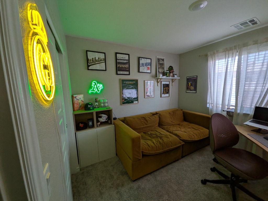 Jacob's home office with Real Madrid and Athletics neon signs and sports memorabilia